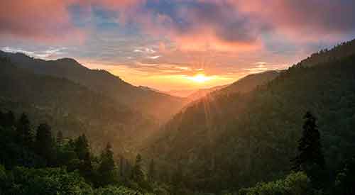 Smoky Mountains with sun shining through clouds