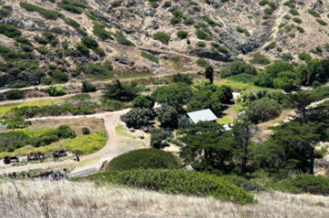 Panoramic view of a few buildings in a valley